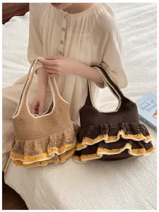 Detail of knit tote bags with three-layer ruffled edges in brown and tan tones