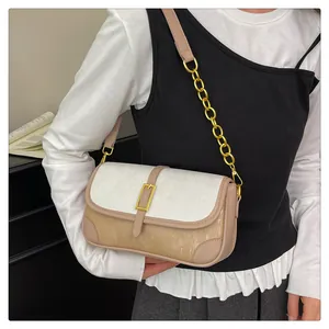 Detail of the chain crossbody bag showing the cream and tan pleated texture with gold hardware