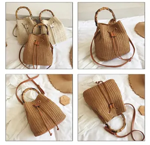 Detail of hand-woven straw bucket bag featuring bamboo handle and drawstring closure