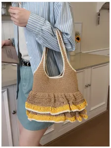Detail view of a handcrafted crochet tote bag with brown knit texture and yellow frilled edges
