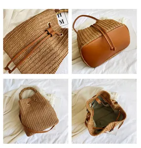 Detail view of woven straw bucket bag featuring bamboo handle and leather base