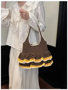 Detail of hand-crocheted coffee tote bag featuring wavy edges and yellow contrast stitching