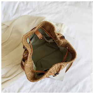 Top view of bucket bag interior showing olive green lining and brown faux leather details