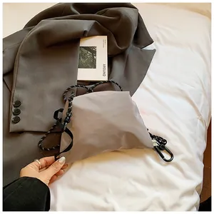 Details der grauen Nylon-Umhängetasche mit gepunktetem Seilgurt und Kunststoff-Karabiner
