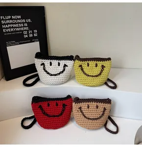 Detail of four handmade knitted bucket bags featuring woven smiley faces on tiered stands