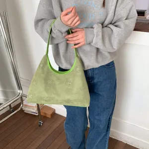 Chic light green suede shoulder bag with white flower patterns and slim strap