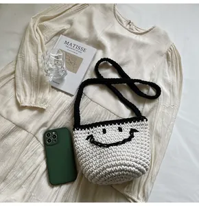 Top view of woven bucket bag with smiley face pattern next to aesthetic lifestyle props