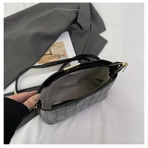 Top view of black crocodile pattern shoulder bag showing interior lining and gold zipper
