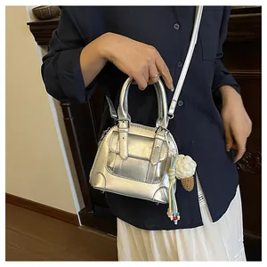Silver metallic mini shell bag with woven ice cream charm and adjustable strap