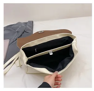 Detail view of cream crocodile textured crossbody bag showing internal compartments