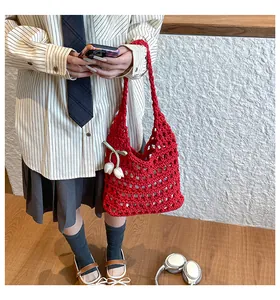 Detail of red hollow crochet knit tote bag with white 3D tulips and ribbon bow