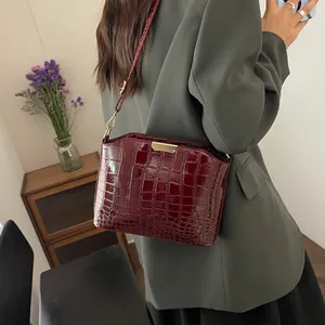 Glossy burgundy crocodile pattern shoulder bag for women with gold metallic hardware accents