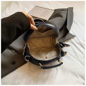 Detailansicht der Jeans-Handtasche mit goldenem Reißverschluss und beigem Futter