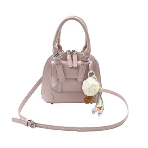 Pink shell handbag for women with ice cream charm and adjustable shoulder strap