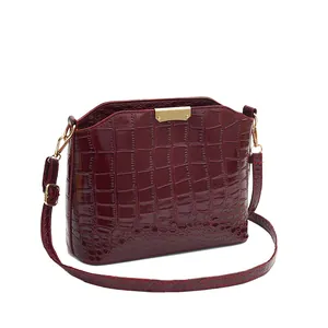 Deep red crocodile embossed patent leather crossbody bag with gold tone hardware