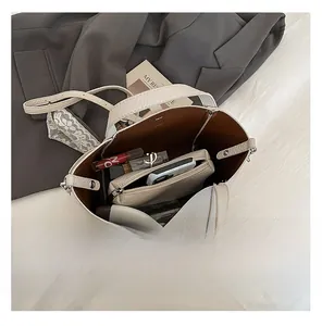 Vue de dessus du sac cabas en cuir crème montrant l'espace de rangement et le contenu