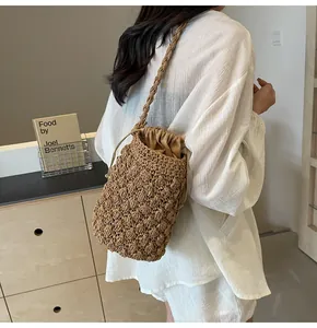 Detail of hand-woven straw bucket bag texture with drawstring lining and shoulder strap