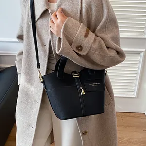 Sac à main chic en cuir noir à motif litchi avec fermoir doré et détail de sangle