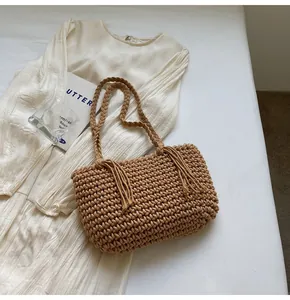 Detailed macro shot of handmade woven tote texture with tassel accents and cotton rope handle