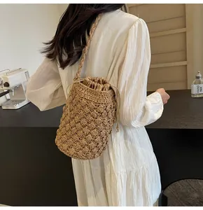 Detail of hand-woven bucket bag featuring a 3D textured knit and drawstring lining
