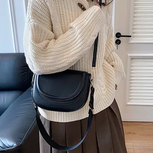 Classic black leather saddle bag with adjustable wide strap for daily commute and fashion