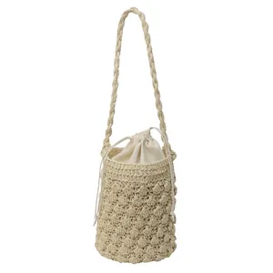 Handmade woven bucket bag with textured crochet details and drawstring inner pouch