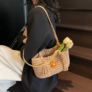 Floral crochet tote bag for beach vacations with woven strap and orange knit flowers