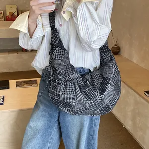 Vintage patchwork crescent hobo bag with monochrome patterns and slouchy denim design