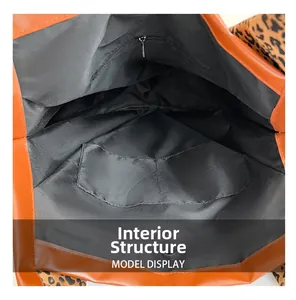 Internal structure of orange tote bag showing zipper pocket and leopard strap