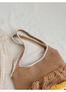 Detail of the cozy knit tote bag showing brown crochet texture and cream contrast edges