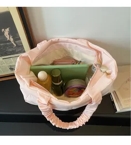 Internal view of pink nylon tote showing spacious storage with inner zipper pocket