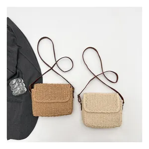 Detailed straw weave texture of khaki and off-white crossbody bags for vacation