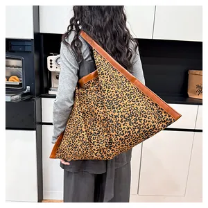 Detail of a large leopard print tote bag featuring a unique triangular origami design