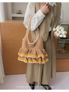Detail of hand-knitted tote bag featuring elegant double-layered ruffled edges in tan