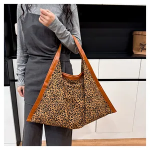 Detailed shot of large capacity leopard print tote bag with brown leather trim detailing