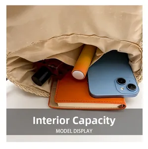 Macro view of straw woven shoulder bag interior showing internal storage capacity