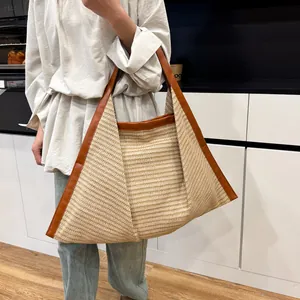 Retro leopard style woven tote bag with brown leather handles in a unique triangular shape