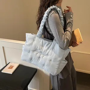 Light blue quilted nylon tote bag with embroidery and ruched shoulder straps for women