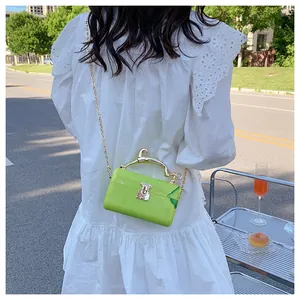Close-up of green marble acrylic crossbody bag with a golden horse handle detail