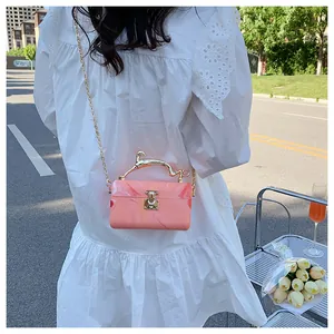 Pink marble acrylic box bag with gold deer-shaped handle and metal chain strap