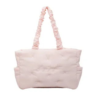 Quilted pink nylon tote bag with bow embroidery and ruffled shoulder straps for daily use