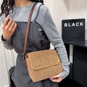 Handwoven straw shoulder bag with adjustable brown strap for spring casual fashion