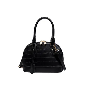 Classic black shell-shaped handbag with crocodile embossed texture and gold hardware