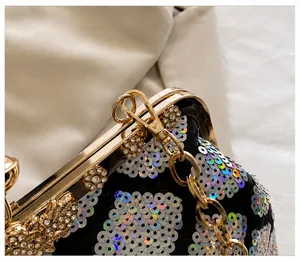 Detail view of iridescent sequin shell bag with detachable gold chain and rhinestones