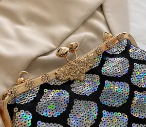 Close-up of golden metal frame with rhinestone flower ornaments and shiny sequins