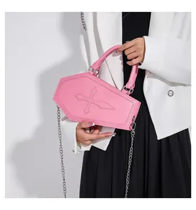 Pink coffin-shaped crossbody bag with cross embossing and silver metal chain detail