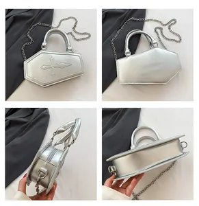Silver coffin shaped handbag with cross detail, metal chain and multiple angle views