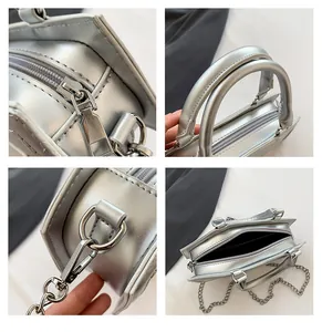 Detail view of silver PU bag featuring metal chain, zipper closure and inner lining
