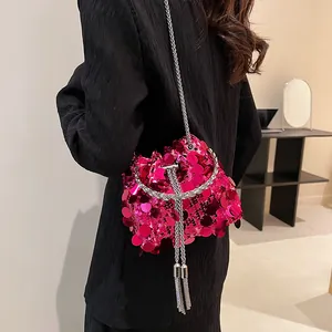 Chic magenta sequin bucket bag with silver chain strap and tassels for party wear