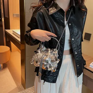 Silver sequin bucket bag with metal ring handle and chain strap for evening wear